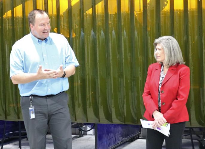 In front of welding stations, Hanson Career Center Director Jim Haag talks with Senator Joni Ernst about the early success of the Forest City-based vocational center..JPG