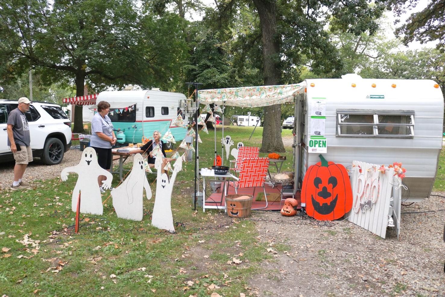 A fellow rally goer visits Dennis and Glenda Gifford of Charles City