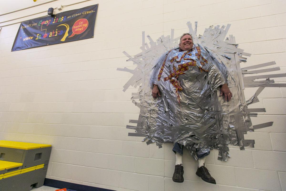 Elementary principal ducttaped to wall in the name of kindness Mason