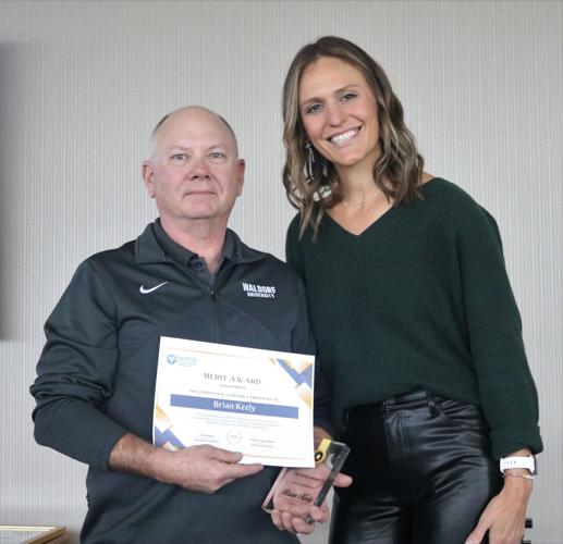 Brian Keely of Waldorf University is shown with his Merit Award alongside Chamber Executive Director Julianna Burkholder. The award is for service to the community..JPG
