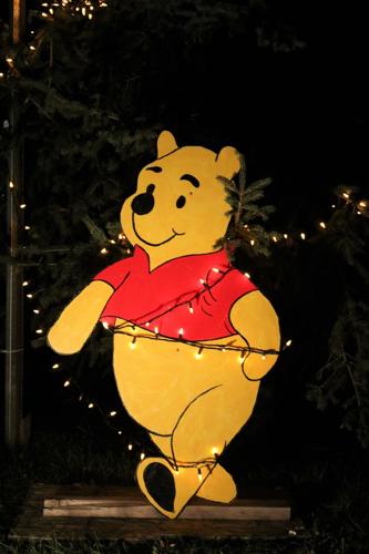 Winnie the Pooh is displayed outside of the 1940s house where scenes for the movie Silent Night in Algona were filmed in Heritage Park recently..JPG