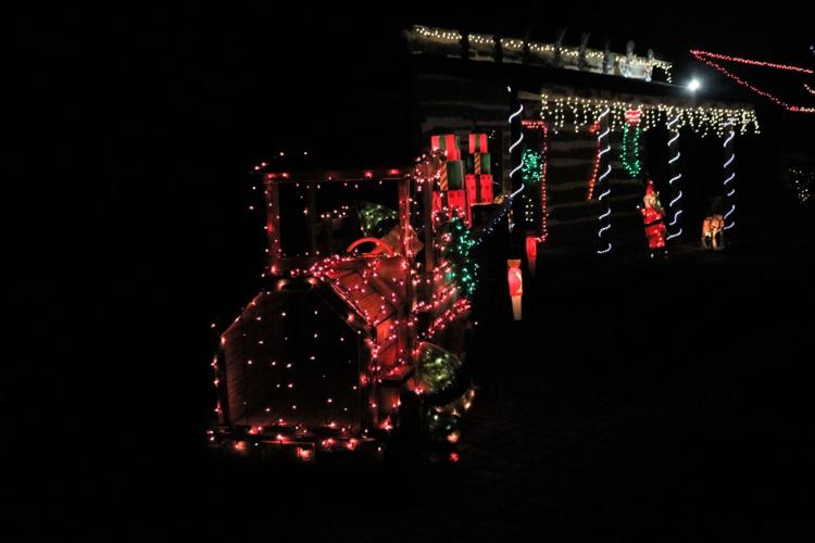 The log cabin house has a vintage engine lighted in front..JPG