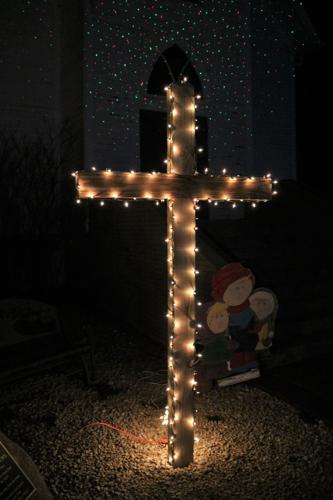 A lighted cross is displayed in front of the Beaver Creek Church at Heritage Park in Forest City..JPG