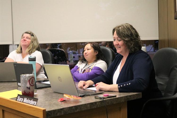 Board Secretary Sara Meinders garners laughs from Keila Buffington, right, and Kim Severson, center..JPG