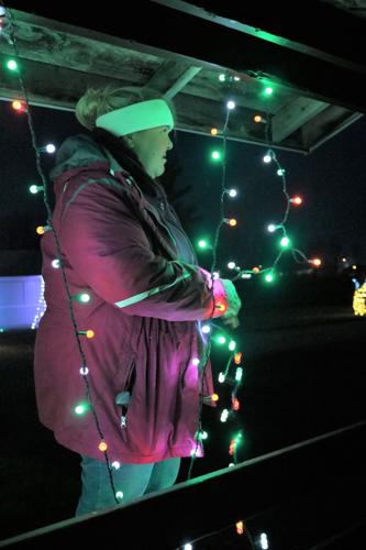 Dawn Arispe stringing lights at Heritage Park as some of the finishing touches for the Holiday Tour of Lights. (2).JPG
