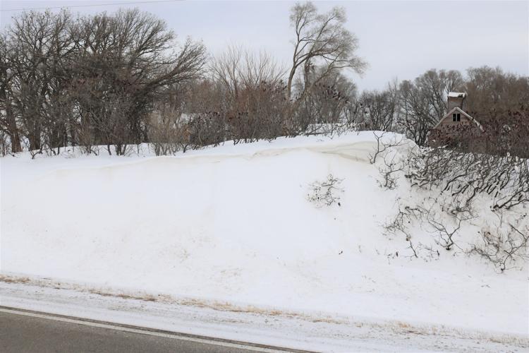 A tall snow drift is shown along 400th Street in rural Winnebago County..JPG