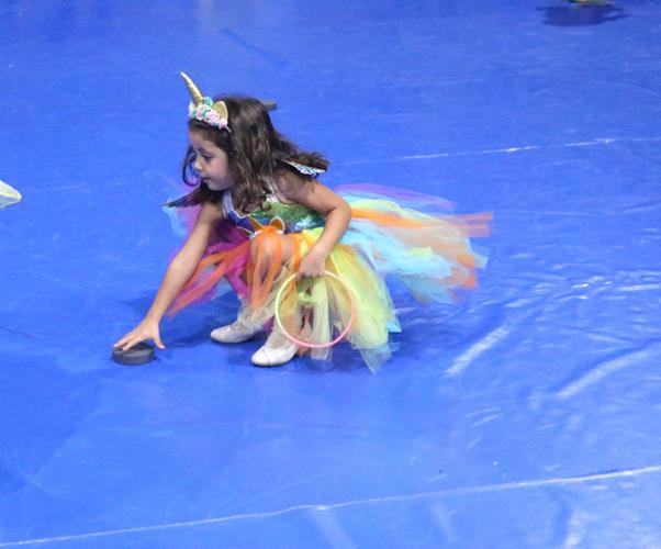 A young girl dressed as a Unicorn turns over a puck to see what color is revealed during a popular game at the Forest City Parks and Rec Elementary Halloween Party..JPG