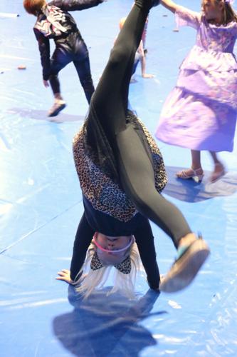 A young girl dressed as a black cat for Halloween does a hand stand on the Civic Auditorium floor..JPG