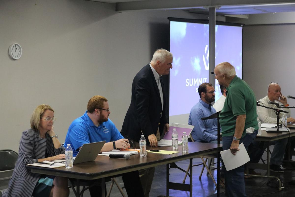 At center, IUB Board Member Richard Lozier greets a dignitary at the start of the Sept. 28 pipeline meeting.  At left is Iowa Consumer Advocate Jennifer Easler..JPG