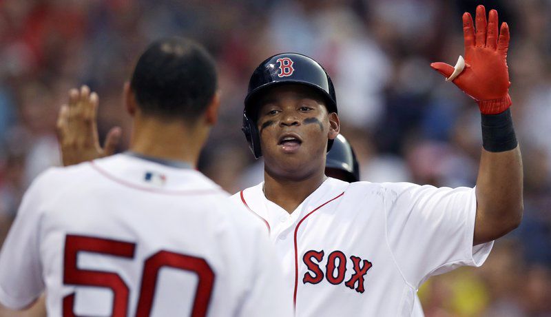 Baby-faced Rafael Devers with a very 90's-amount of chew in his