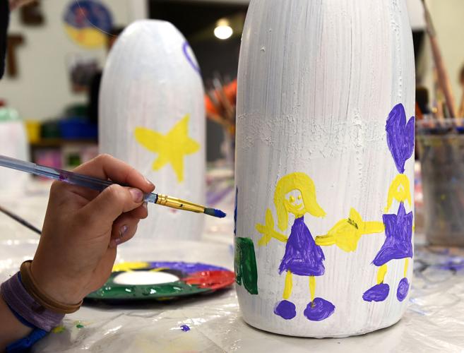 Gilding the buoys: Children paint ornaments for Lobster Trap Tree, News