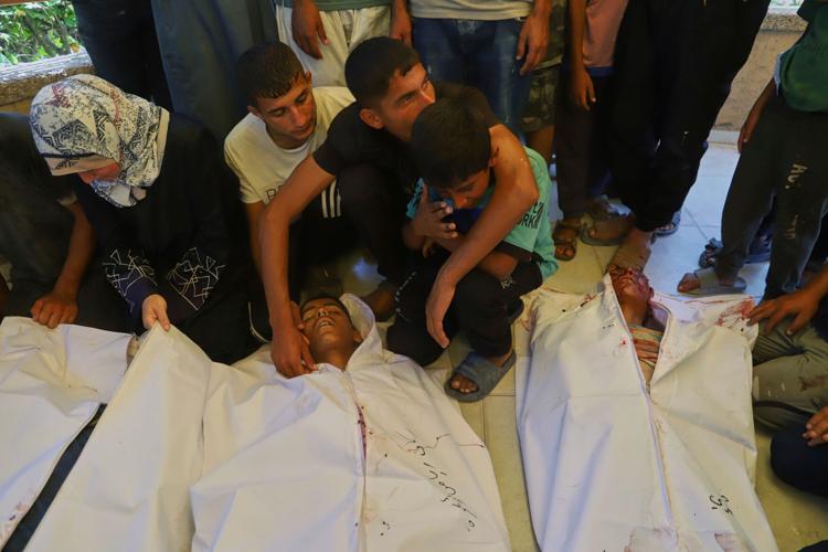 74 killed in Gaza as Israeli forces strike a cafe and fire on people