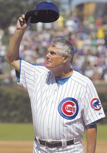 Chicago Cubs general manager Jim Hendry (R) puts a jersey on