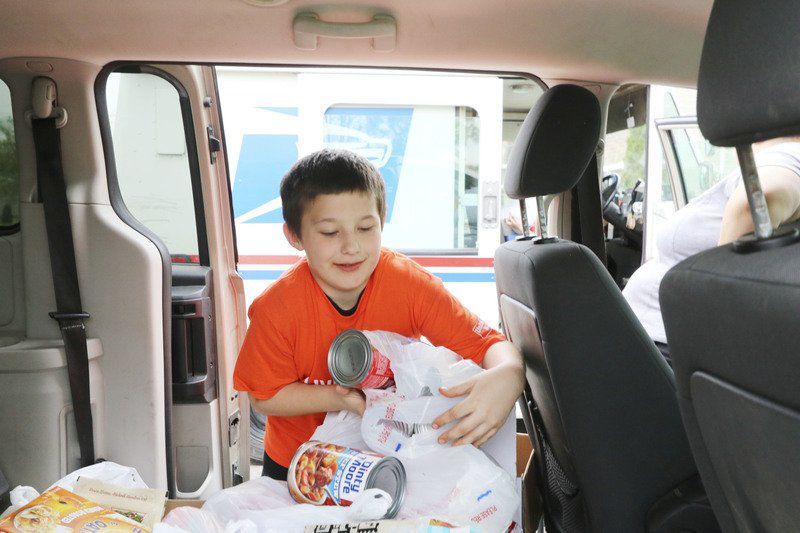 Volunteers help deliver relief for food needs