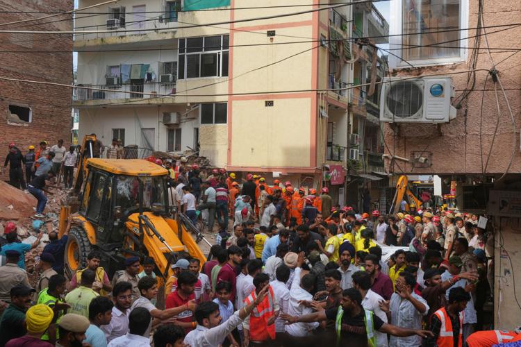 Building collapse in New Delhi kills 1 and traps dozens of others ...