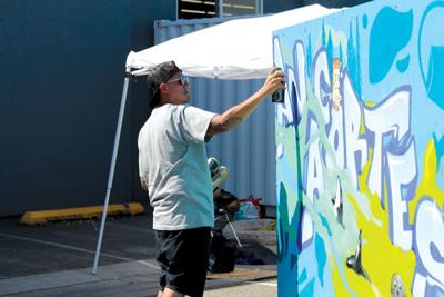 Father Son Use Spray Paint To Create Three Sided Work Of Art