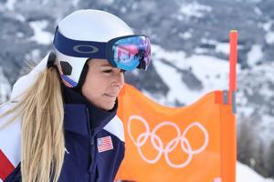 Lindsey Vonn clips gate and crashes in Winter Olympic downhill, taken away by helicopter