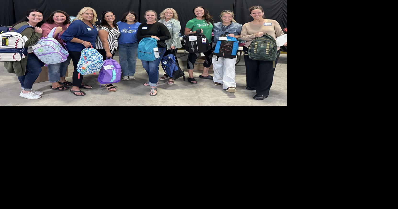 Community shows up to pack backpacks for Stuff the Bus | Business ...