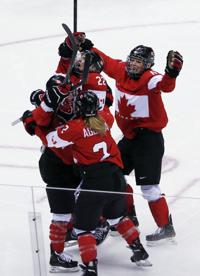 USA defenseman Anne Schleper (15) cross checks Canada forward Jayna Hefford  (16) in the second period of the women's hockey gold medal game at the  Bolshoy Ice Dome during the Winter Olympics