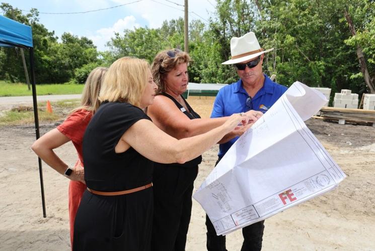 Villas on Scott looking over plans Denise Dull second from right