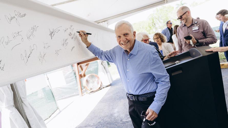 Supporters sign beam during NCH ceremony