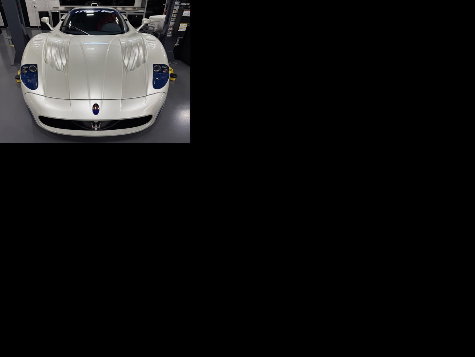 A Maserati MC12 is showcased inside DuPont Registry’s Naples-area showroom, highlighting the high-end and rare vehicles featured at the newly opened luxury auto facility.