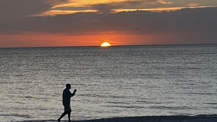 Visitors gather for sunset on Collier County beach