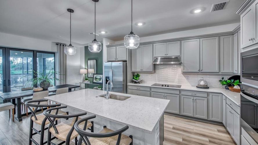 A model home kitchen illustrates the open floor plans planned for Cassia Bay, where PulteGroup homes will range from 1,256 to 2,703 square feet with three to four bedrooms and two- and three-car garages.