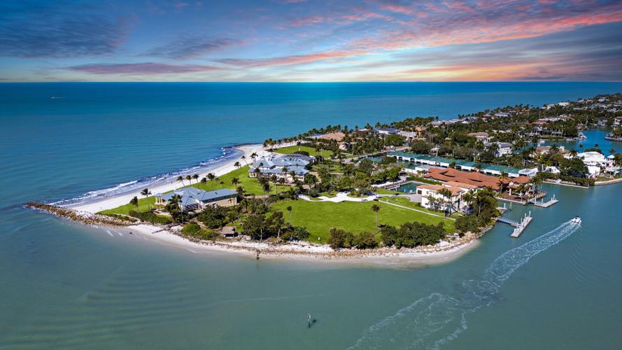 An aerial view shows Gordon Pointe, a nearly 9-acre private peninsula estate at 100 Bay Road in Naples, with frontage on both the Gulf of Mexico and Naples Bay. The legacy compound has returned to the market after a previous record-setting listing in 2024.