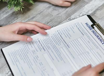 Person reviews home insurance form