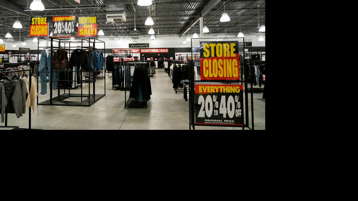 Discount signs fill sales floor at closing Saks Off 5th