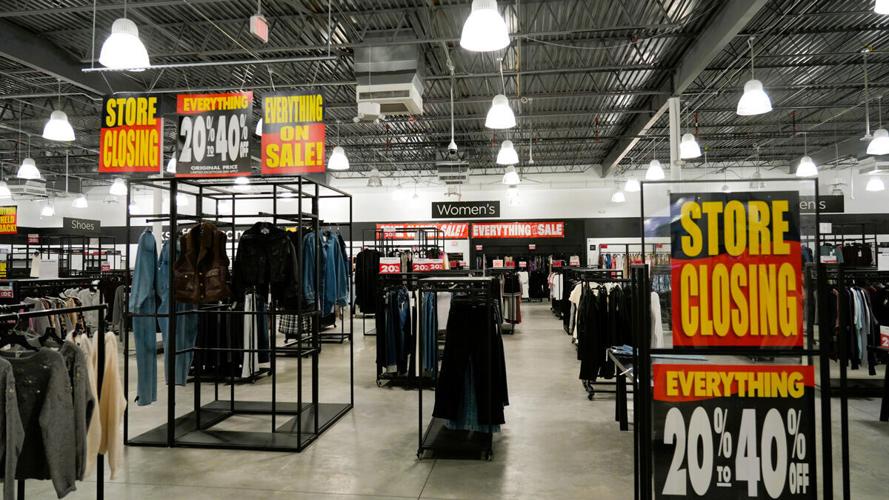 Discount signs fill sales floor at closing Saks Off 5th