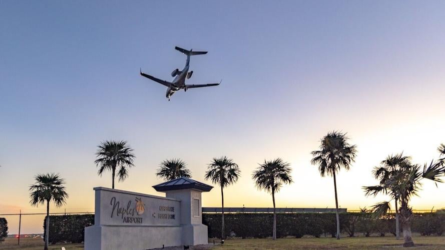 A jet makes its final approach into Naples Airport as the sun sets on the horizon.jpg