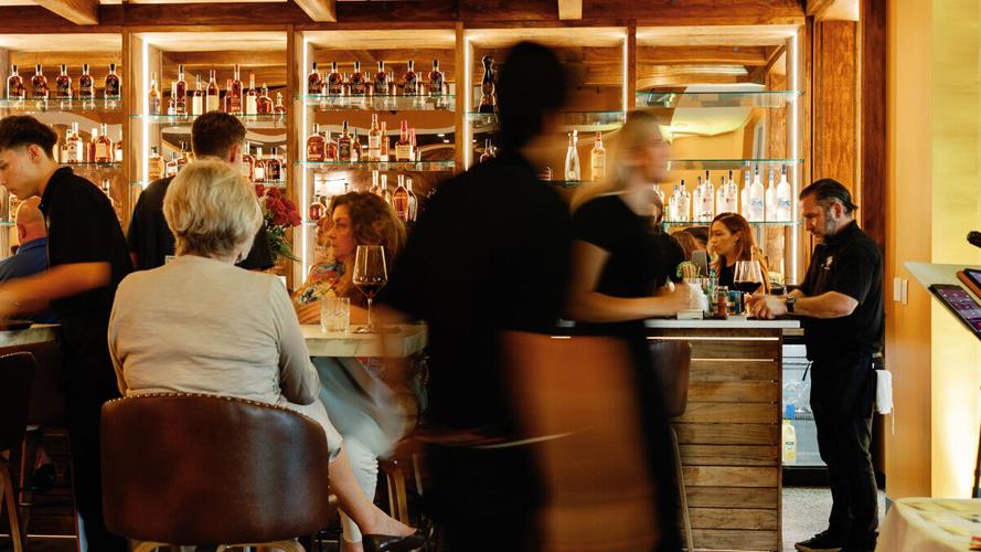 Bartenders serve guests at Vybe bar