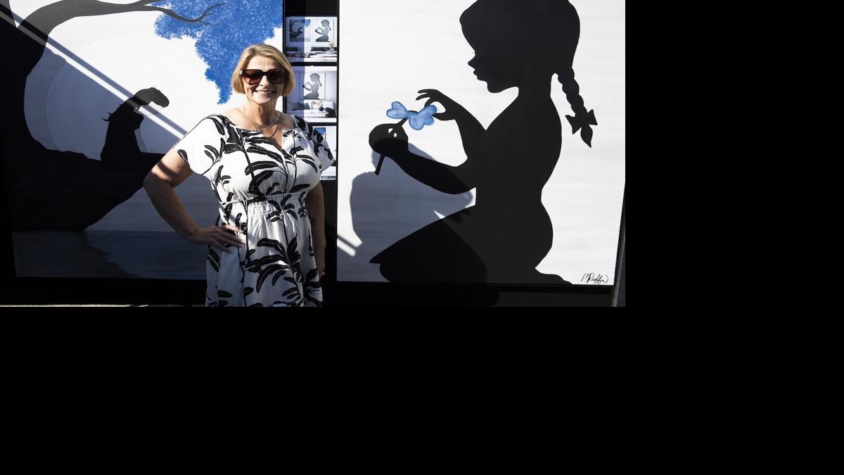 Bonnie Ruffin stands in her booth at Coconut Point New Year's Art Festival on Dec. 28.jpg