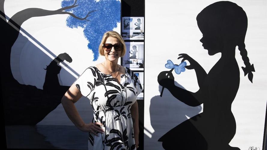 Bonnie Ruffin stands in her booth at Coconut Point New Year's Art Festival on Dec. 28.jpg