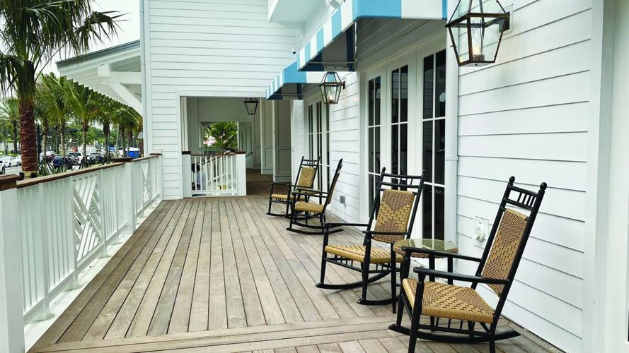 Rocking chairs line hotel veranda in Naples