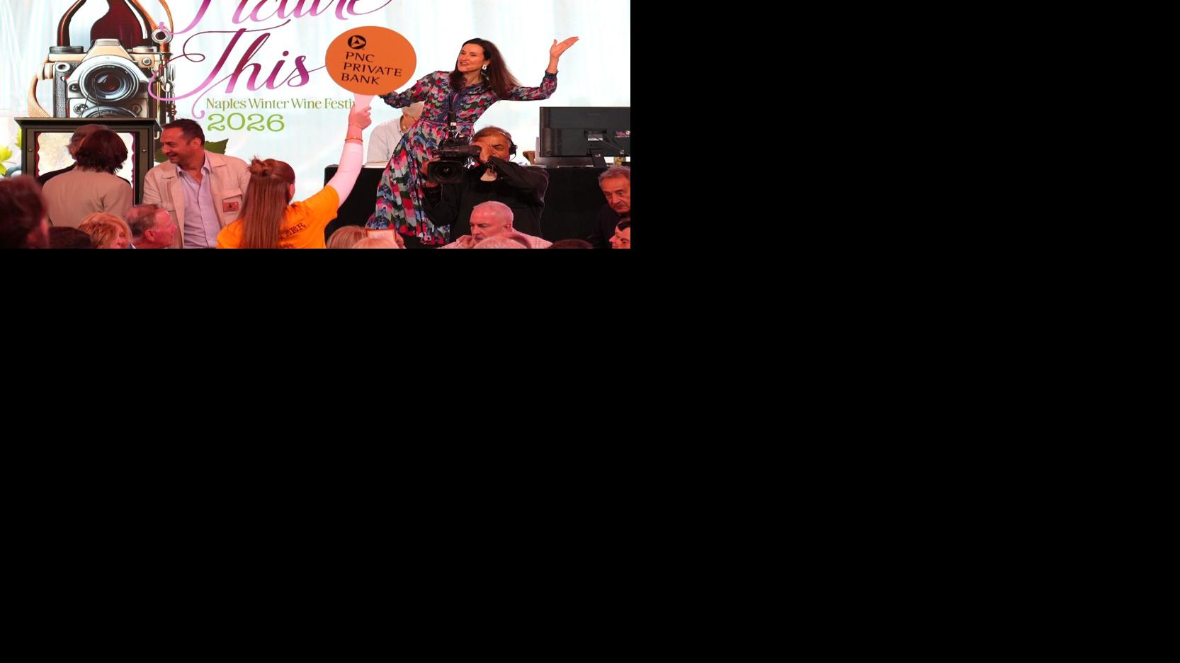 A video screen flashes a winning bid announcement as guests applaud during the Naples Winter Wine Festival live auction Jan. 31 at The Ritz-Carlton Naples, Tiburón.