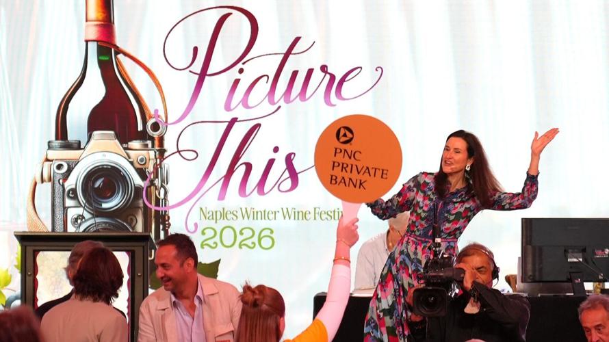 A video screen flashes a winning bid announcement as guests applaud during the Naples Winter Wine Festival live auction Jan. 31 at The Ritz-Carlton Naples, Tiburón.