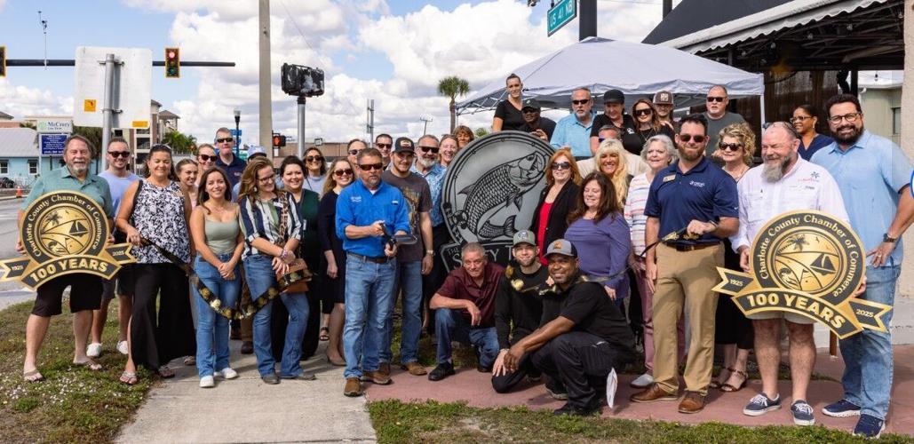 The Salty Tarpon USE Owner Kenny Tyner cuts the ribbon, his son Devin Tyner is to his left in photo_.jpg