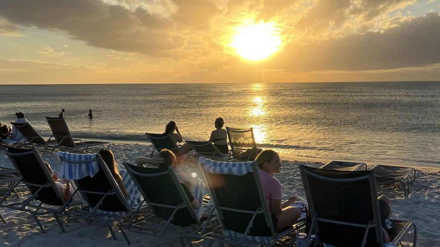 Visitors gather for sunset on Collier County beach