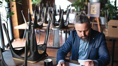 Business owner reviews finances during off-season slowdown