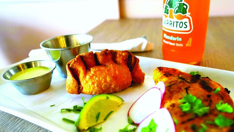 Chicken-and-poblano empanadas and birria tacos at Barrio Taqueria