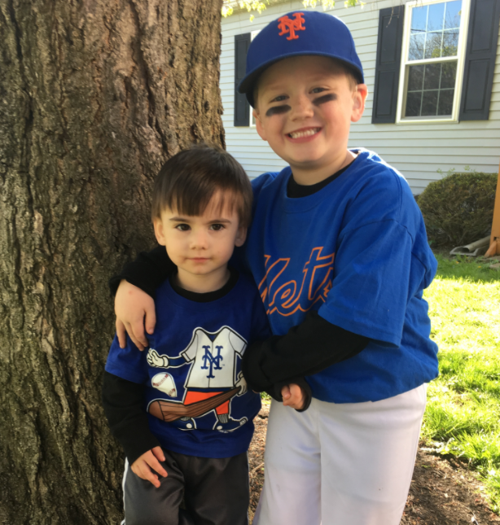 Little brother Colin loves cheering on big brother Lochlan ...
