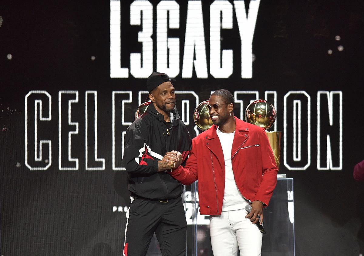 In this file photo, Dwayn Wade and Udonis Haslem rap to begin the Dwyane Wade Legacy Celebration, Friday, February 21, 2020, at AmericanAirlines Arena. Wade recently said "people think its easy to bring 15 guys together and win a championship and play as a team. Right now, we're asking the whole country to play as a team. You see how hard it is."