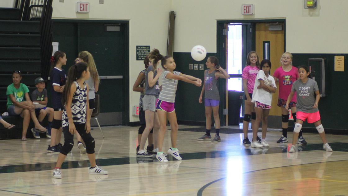 Girls learn volleyball at youth clinic Sports