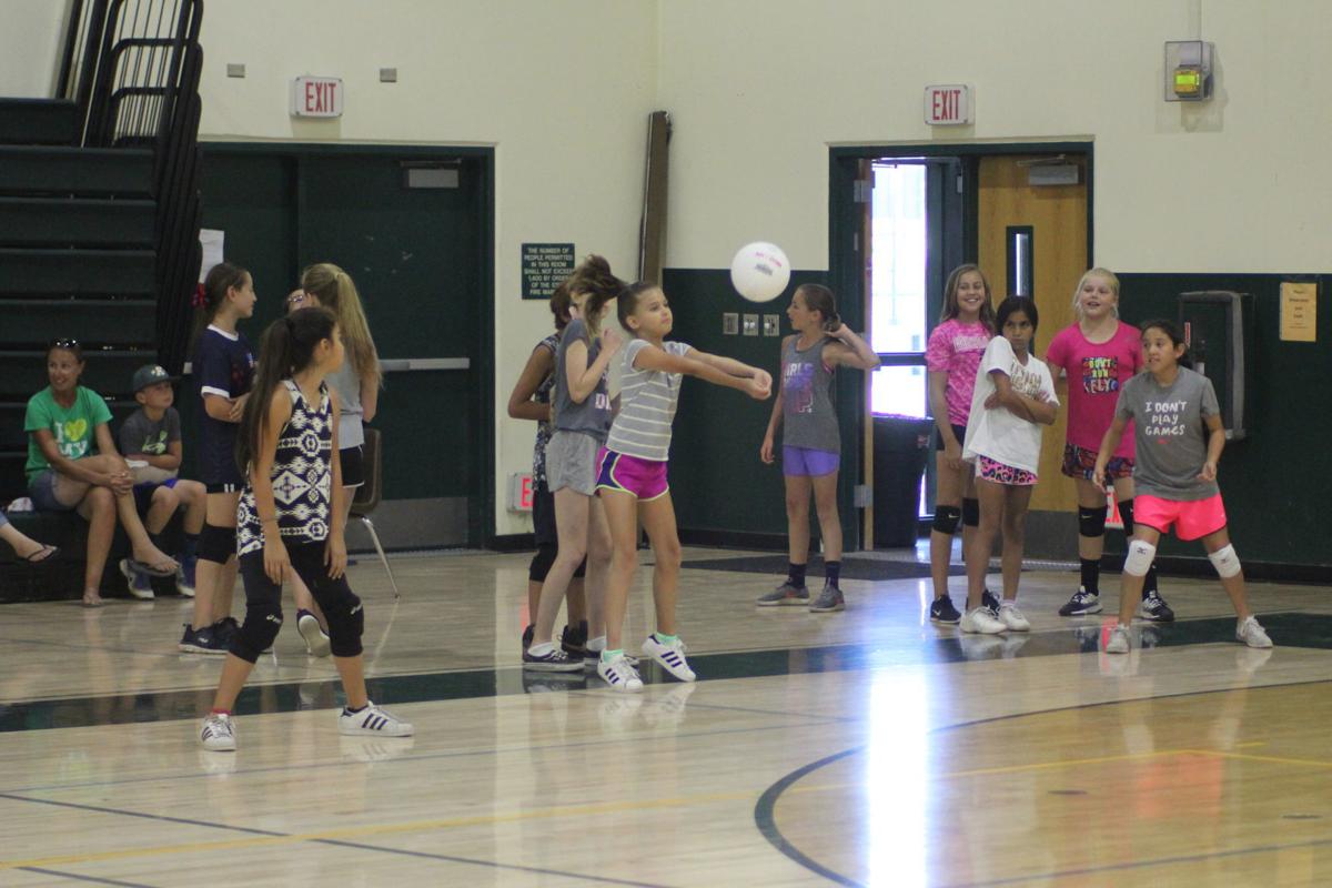 Girls learn volleyball at youth clinic Sports