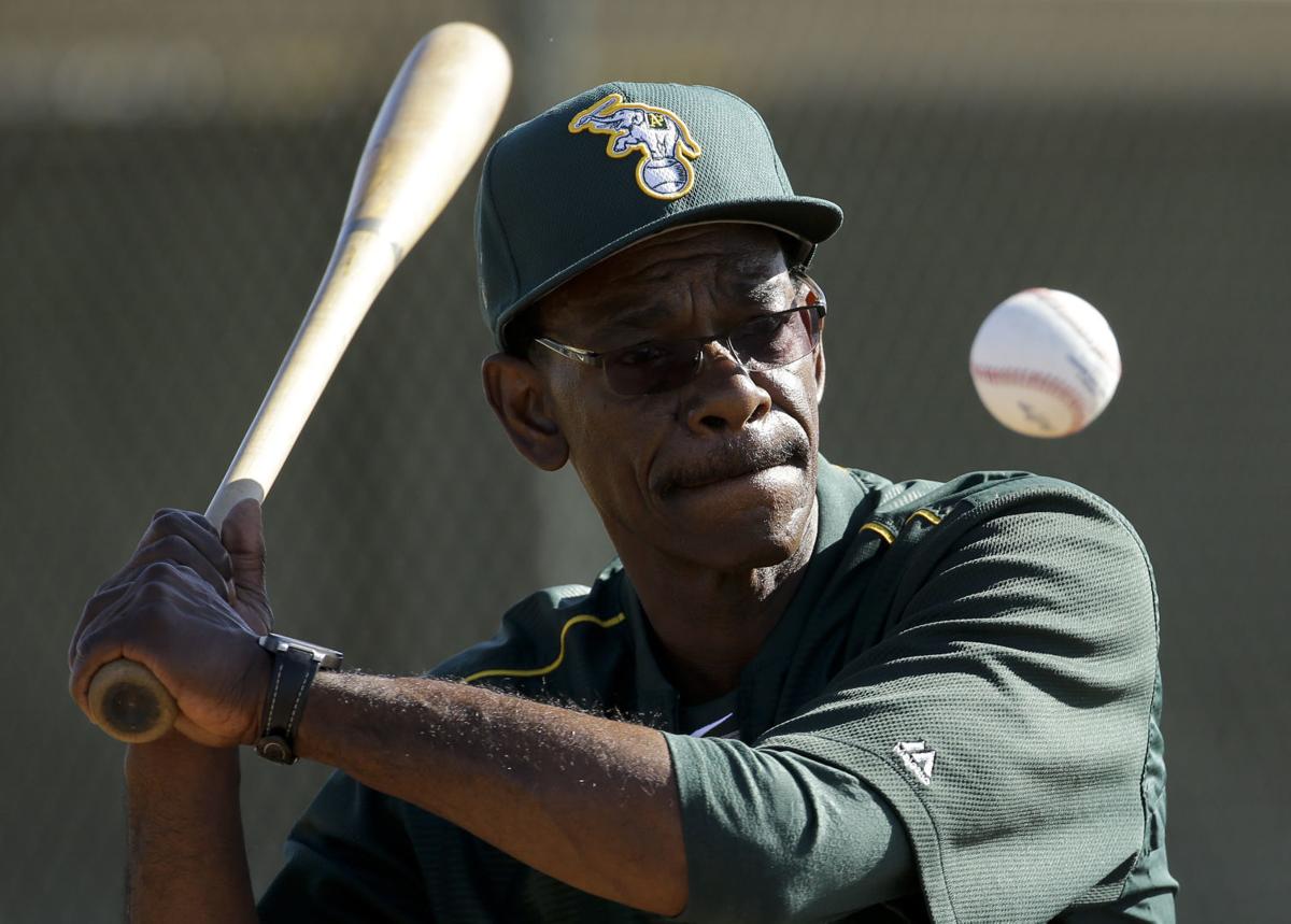 A’s coach Ron Washington putting infielders through drills at crack of