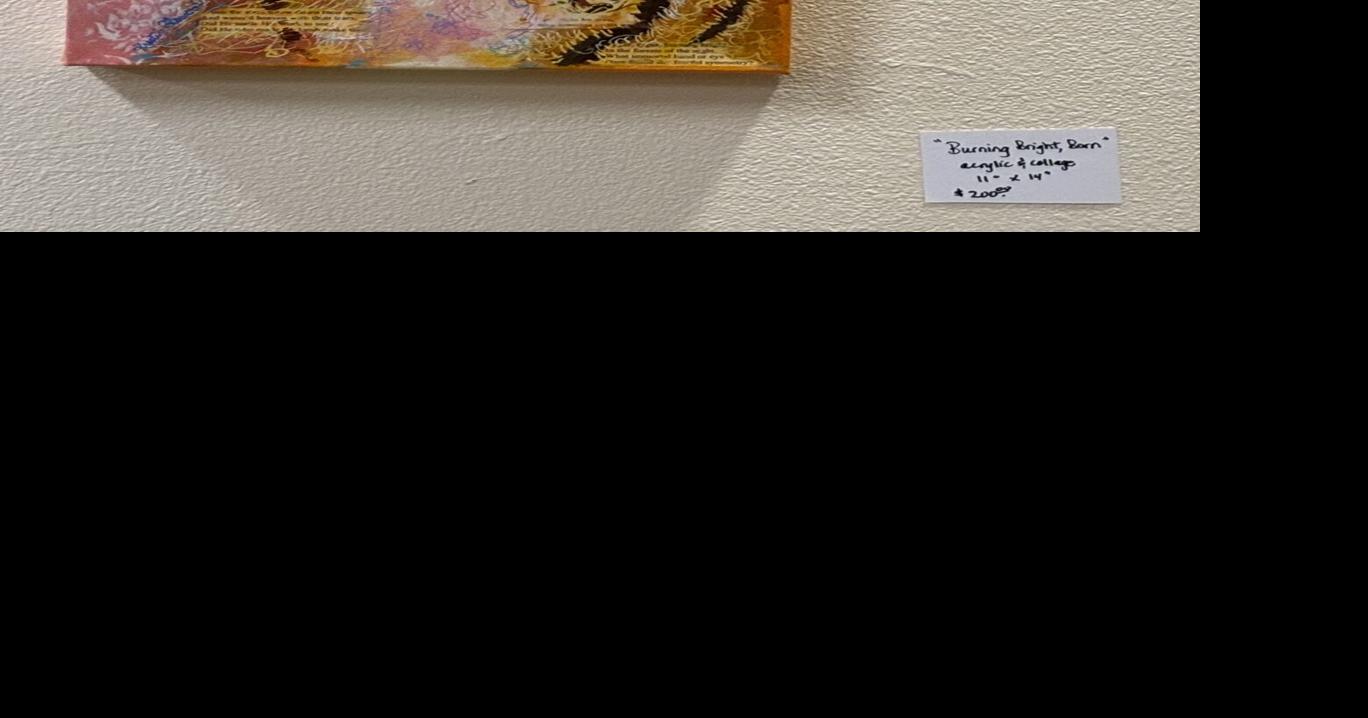 The faces of local artist Kristin Flowers on display downtown