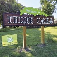 Restored signs welcome motorists to Three Oaks